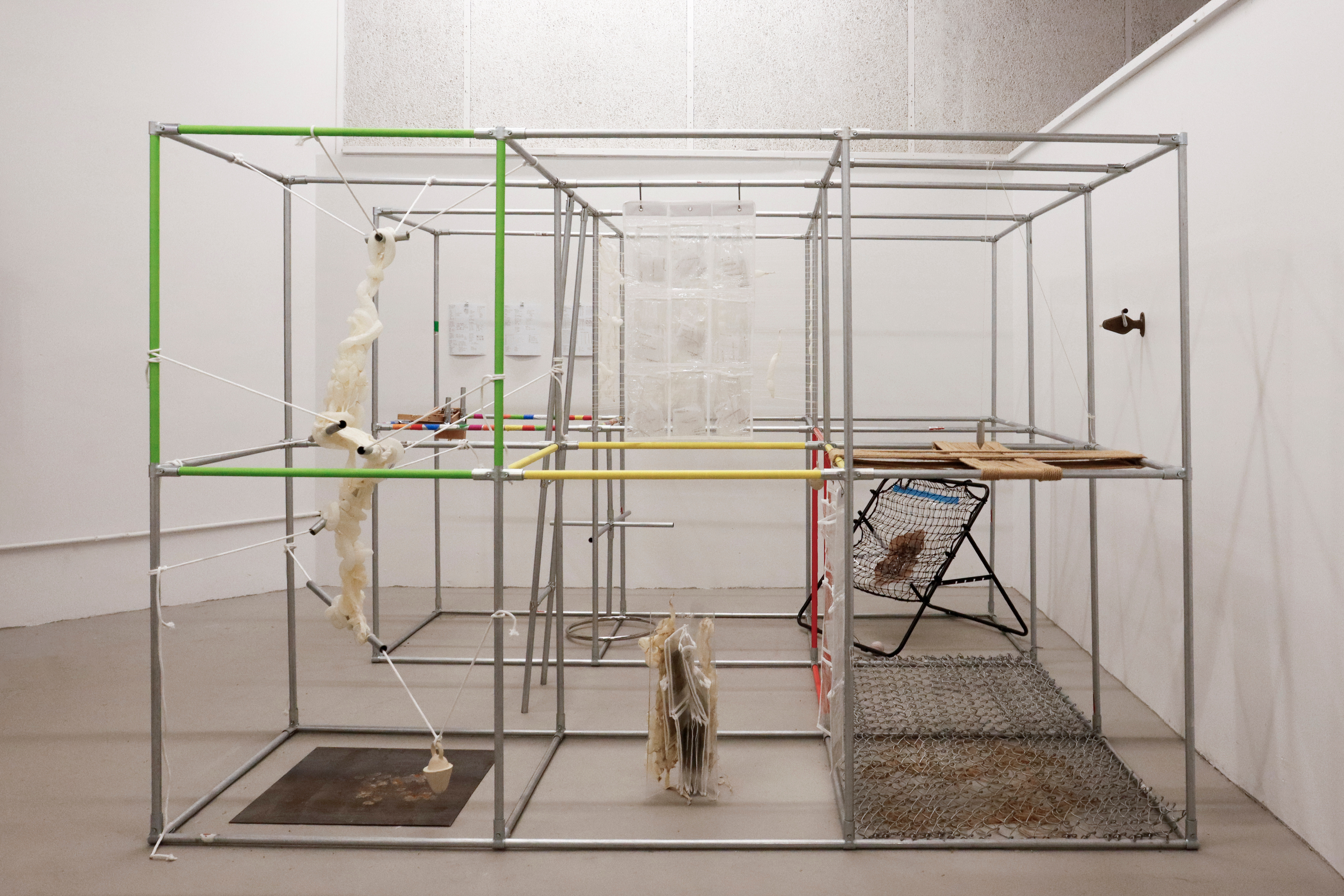 Shifting Center participatory installation by oneg - modular metal framework holding woven hog casing and suspended objects